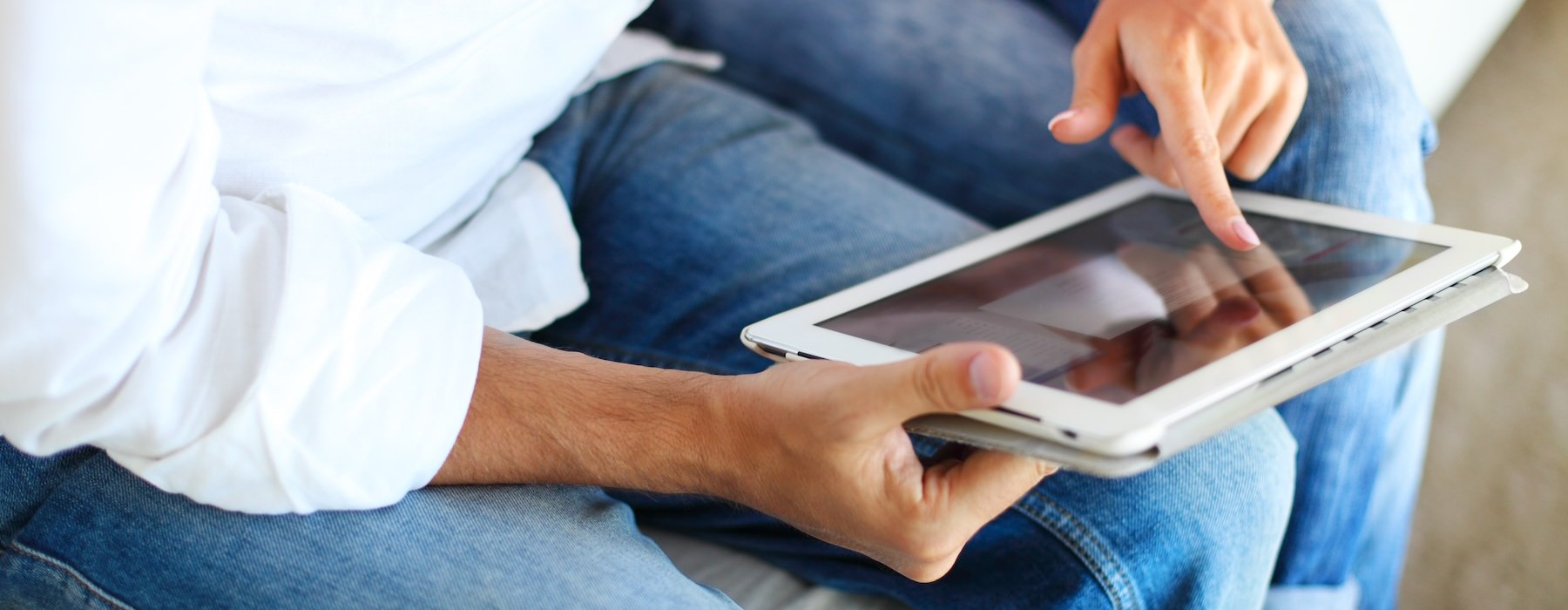 close up of a person holding a tablet